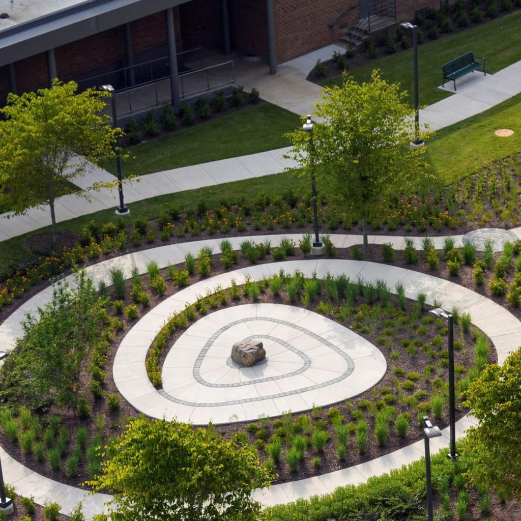 The meditation labyrinth from above, showing the plants and trees that border the maze path.